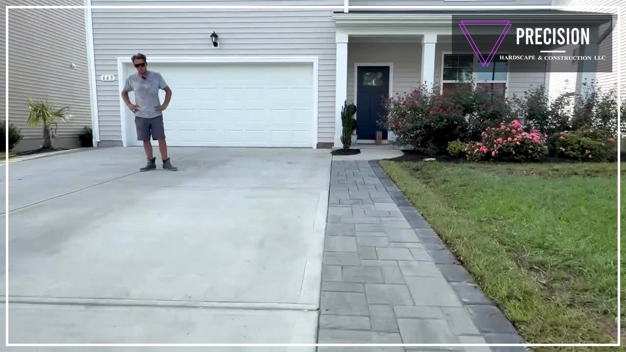 Paver driveway extension with charcoal border and curb flare beside a coastal Carolina home — Precision Hardscape & Construction