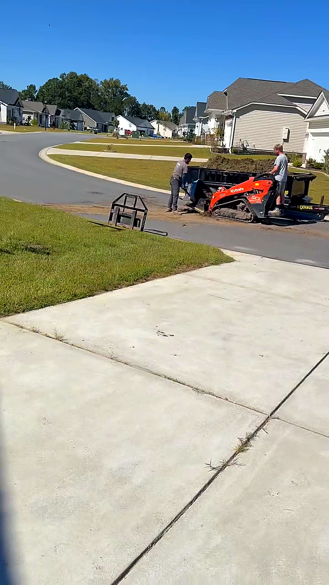 Crew and skid steer loader moving topsoil at a residential lawn repair job in Conway South Carolina